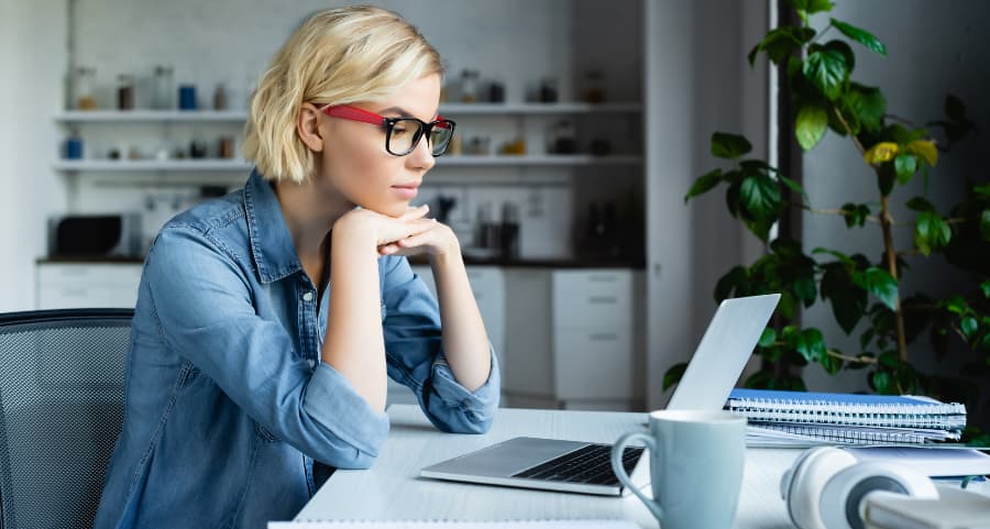 Individual using computer in home workspace